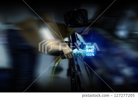 Power cable pump plug in charging power to electric vehicle EV car. 127277205