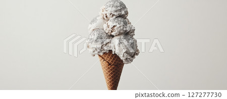 Ice cream cone with scoops of vanilla ice cream and sprinkles 127277730