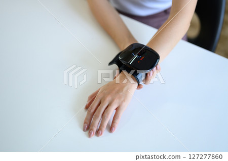 Closeup woman check up low blood pressure with digital pressure monitor, Hypotension problem Closeup woman check up low blood pressure with digital pressure monitor, Hypotension problem 127277860