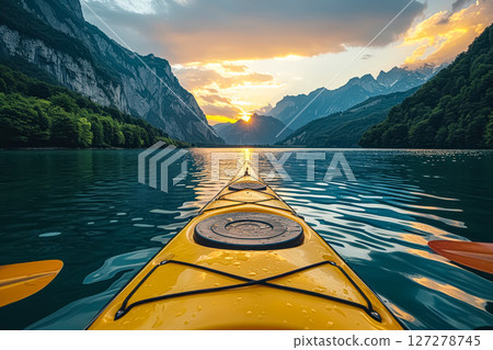 Yellow canoe is floating in a blue river. 127278745