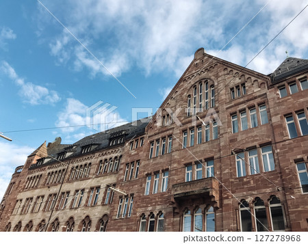 A large brick building with a blue sky in the background A large brick building with a blue sky in the background 127278968
