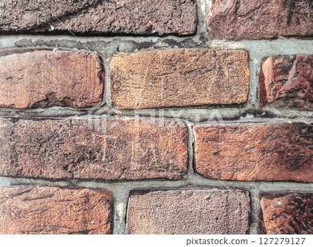 A brick wall with a brown and tan color 127279127