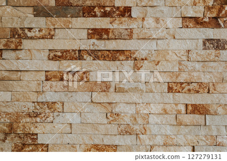 A brick wall with brown and white bricks A brick wall with brown and white bricks 127279131