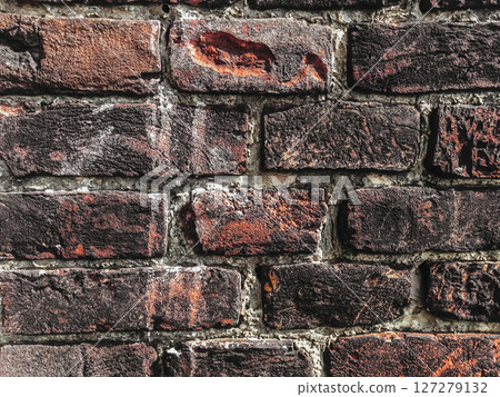 A brick wall with a few holes in it 127279132