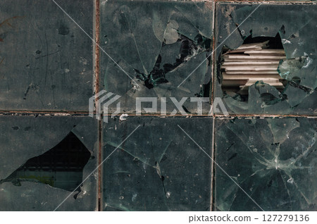 A broken window with a hole in it A broken window with a hole in it 127279136