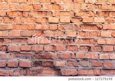 A brick wall with a few holes in it 127279149