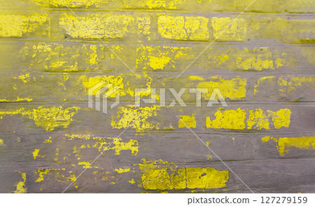 A yellow brick wall with yellow paint on it A yellow brick wall with yellow paint on it 127279159