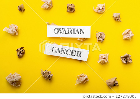 A yellow background with two pieces of paper that say Ovarian Cancer A yellow background with two pieces of paper that say Ovarian Cancer 127279303