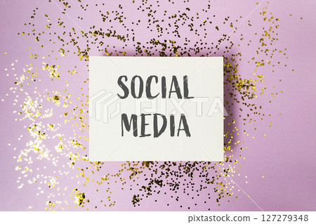 White card with gold glitter and the word social media written on it 127279348