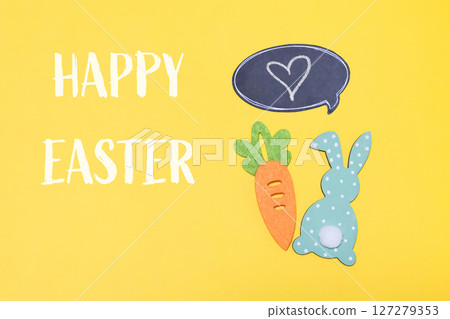 Yellow background with a carrot and a rabbit on it 127279353