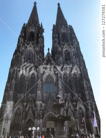 Cathedral in Cologne. The two tall towers of a cathedral are lit up by the sun 127279381