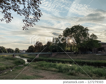 River runs through a park with a bridge over it River runs through a park with a bridge over it 127279383
