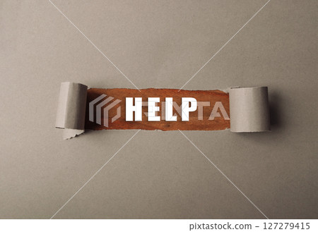 Torn piece of paper with the word HELP written on it 127279415