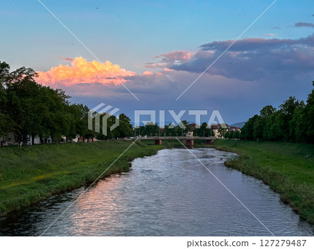 River with a bridge over it and a beautiful sunset in the background River with a bridge over it and a beautiful sunset in the background 127279487