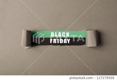 Torn piece of paper with the words Black Friday written on it 127279508