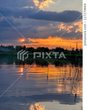 Serene Sunset Reflection Over a Tranquil Lake 127279669