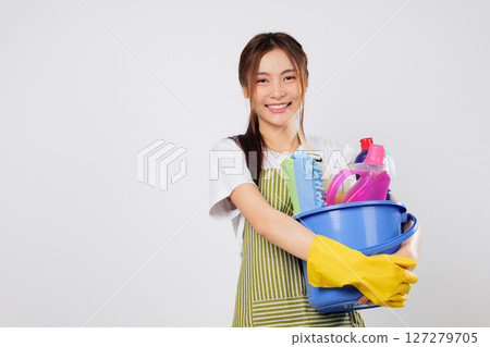 Cleaning tools and bucket of supplies in hand, woman ready to start cleaning with confidence and all the supplies at her fingertips. isolated studio white background 127279705