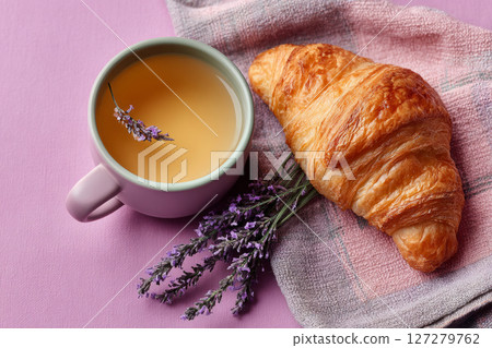 Bright breakfast with croissant, tea and lavender bouquet 127279762