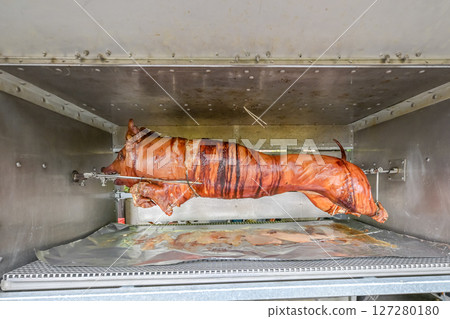 Barbecue with young pig grill Whole roasted piglet body turning on grill. Large barbecue in the process of cooking meat Barbecue with young pig grill Whole roasted piglet body turning on grill. Large barbecue in the process of cooking meat 127280180