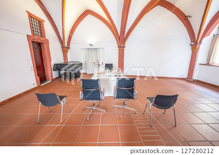 Luxurious wedding setup with round tables, stylish chairs, and beautiful floral decorations creating romantic atmosphere 127280212