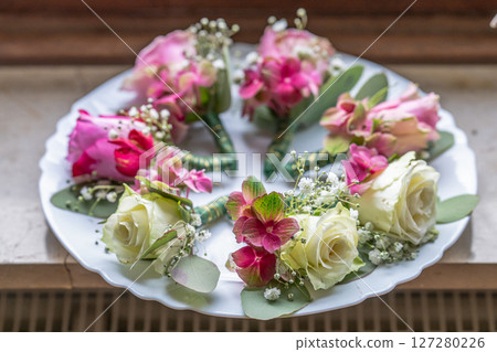 Small stylish boutonnieres on white marble plate, flat lay colorful many groom Small stylish boutonnieres on white marble plate, flat lay colorful many groom 127280226