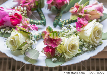 Small stylish boutonnieres on white marble plate, flat lay colorful many groom Small stylish boutonnieres on white marble plate, flat lay colorful many groom 127280227
