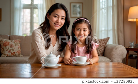 Mother and Daughter Having Tea in Cozy Living Room 127280923