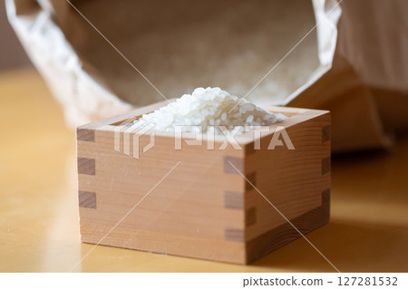 White rice in a wooden box and a rice bag White rice in a wooden box and a rice bag 127281532