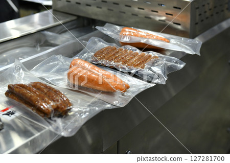 High-performance machines are wrapping food products food in production lines on conveyor belts, food production industry 127281700