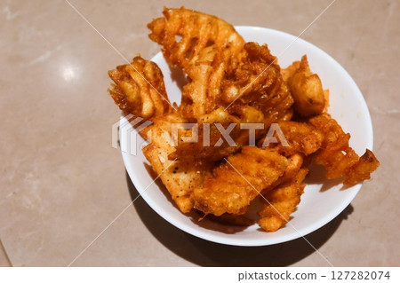 close up of deep fried potato crinkle criss cut snacks with copy space close up of deep fried potato crinkle criss cut snacks with copy space 127282074