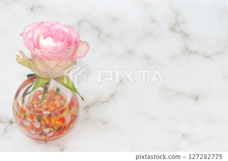 Horizontal layout, warm-colored, spherical vase with roses, left side 127282775