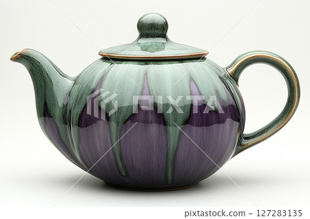 Ceramic teapot in shape of a purple eggplant in a classic style on a white background. Ceramic teapot in shape of a purple eggplant in a classic style on a white background. 127283135