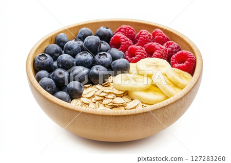 Vibrant Healthy Breakfast Bowl Featuring Fresh Fruits, Oats, and Nuts Arranged Neatly for a Delightful Start 127283260