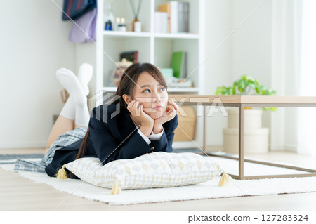 A high school girl worried in her room 127283324