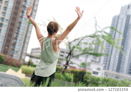 Joyful asian woman 30s fitness yoga workout. Stretching exercise reduces medical injury risk, shoulder pain, muscle strain, inflammation. Wellness healthcare for healthy lifestyle urban city Joyful asian woman 30s fitness yoga workout. Stretching exercise reduces medical injury risk, shoulder pain, muscle strain, inflammation. Wellness healthcare for healthy lifestyle urban city 127283359