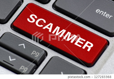 Scammer text on laptop keyboard indicating where users are being attached by scammer 127283368