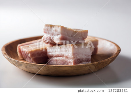 Close up of view of pork belly on a wooden plate. Meat concept 127283381