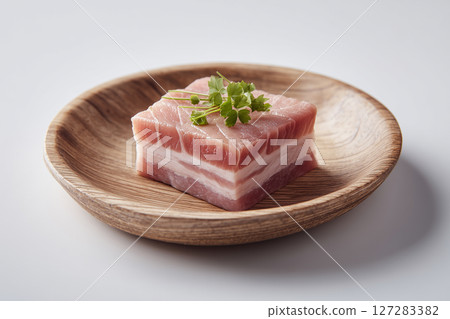 45 degree angle view of slices of pork belly on a wooden plate. Meat concept 45 degree angle view of slices of pork belly on a wooden plate. Meat concept 127283382