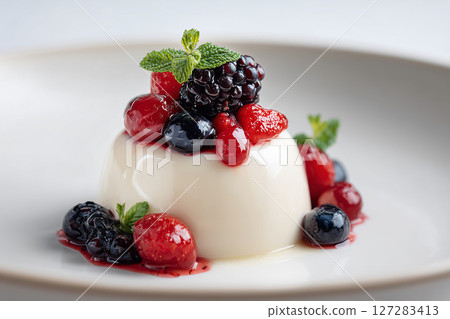 Creamy Panna Cotta with Mixed Berries Garnish 127283413