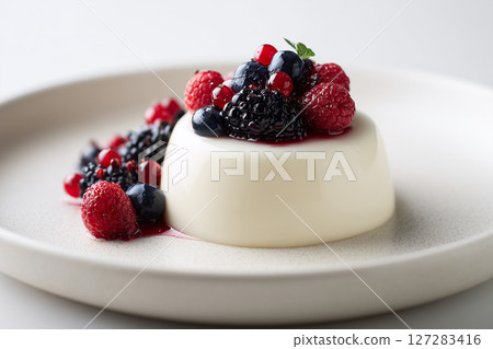 Panna Cotta with Berries on White Plate isolated on white background cover Panna Cotta with Berries on White Plate isolated on white background cover 127283416