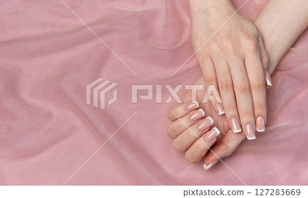 Woman showing french manicure on pink background Woman showing french manicure on pink background 127283669