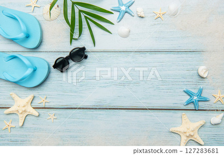 Summer beach essentials on wooden background Summer beach essentials on wooden background 127283681