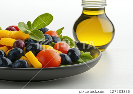 Fresh Clean Salad with Colorful Vegetables and Olive Oil in a Jar on a Bright Background 127283886