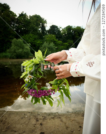 Midsummer solstice holiday with flower wreath Midsummer solstice holiday with flower wreath 127284569