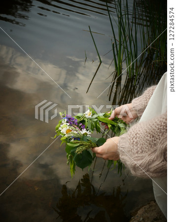Midsummer solstice holiday with flower wreath 127284574
