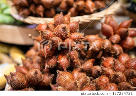 Salak snake food fruit in basket at market stall, healthy grocery food choosing in store Salak snake food fruit in basket at market stall, healthy grocery food choosing in store 127284721