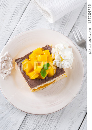 Square Mango Cheesecake With Chocolate Glaze, Fresh Cubes, and Whipped Cream 127284736