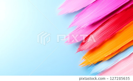 Colorful brushstrokes creating vibrant diagonal lines on light blue background 127285635