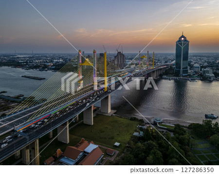 Thotsamarachan Bridge (Rama IX Bridge) crossing Chao phraya river. Beautiful city of Bangkok during sunset time. 127286350