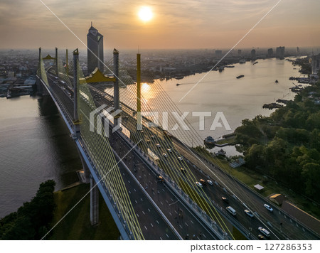 Thotsamarachan Bridge (Rama IX Bridge) crossing Chao phraya river. Beautiful city of Bangkok during sunset time. 127286353